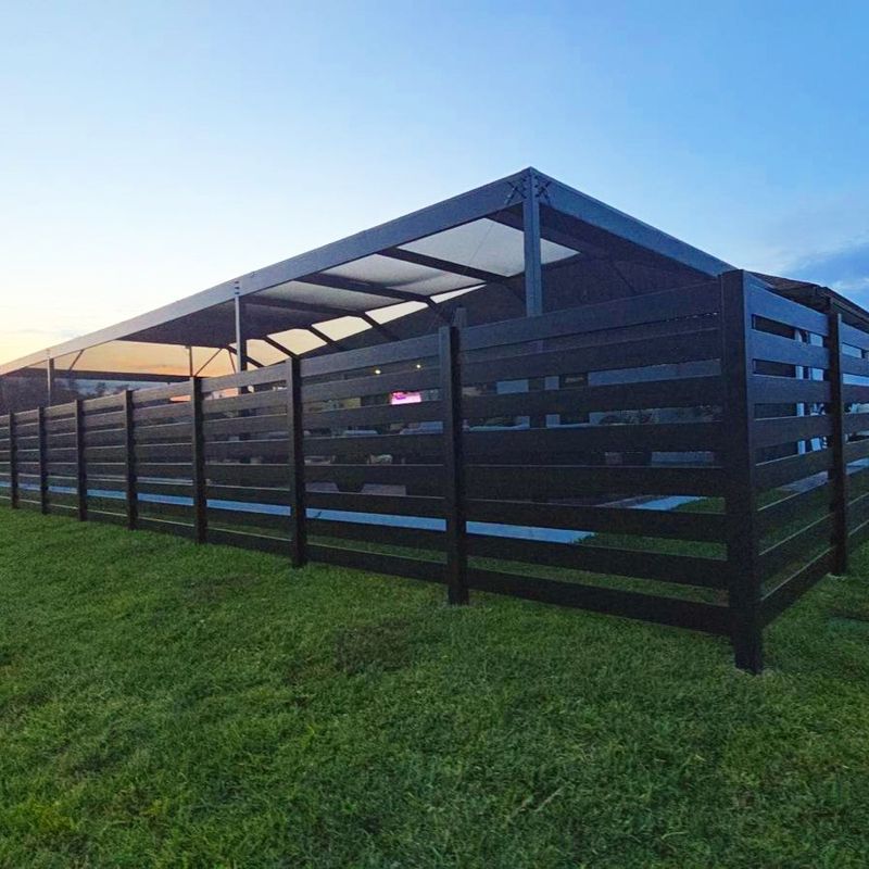 Quickscreen slat fence around a screened patio at sunset