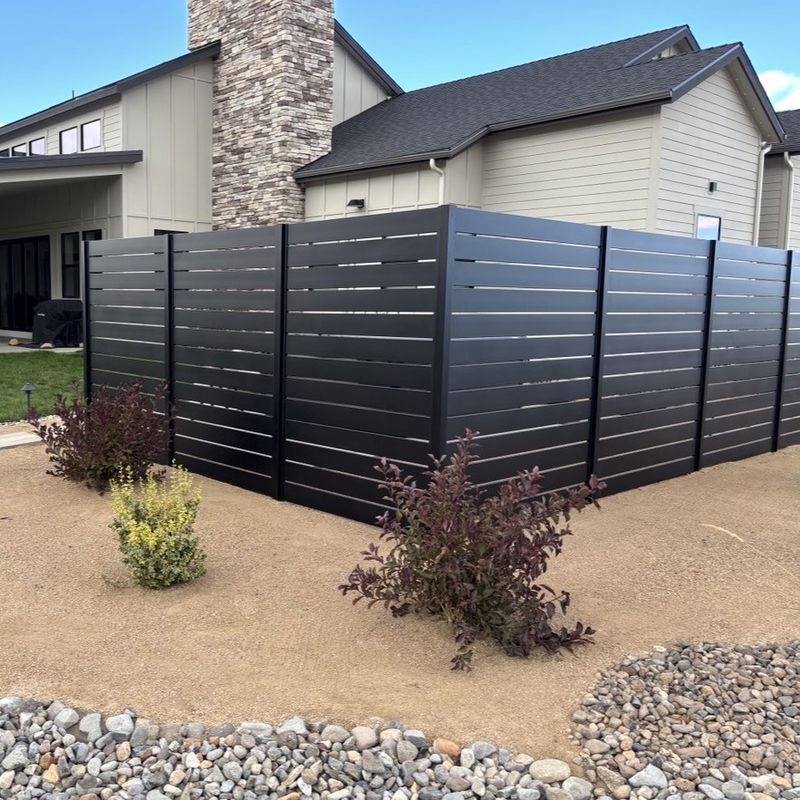 Black Quickscreen privacy fence around a landscaped yard